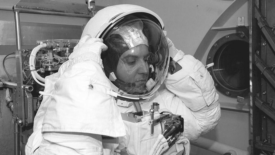 NASA engineer, Luca Callini, putting on his spacesuit helmet